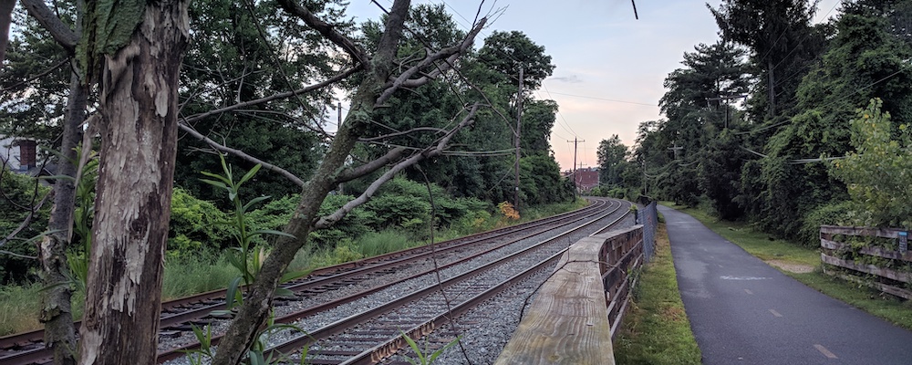 Train tracks and bike path head into the distance