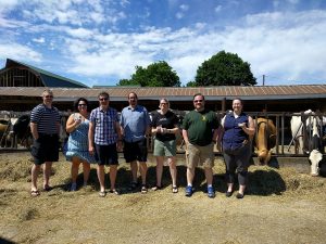 Group photo with cows at Cook's Farm