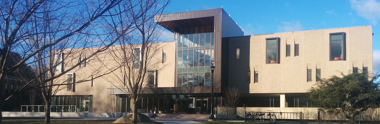 Boxy three-story rectangular building with glassed-in center